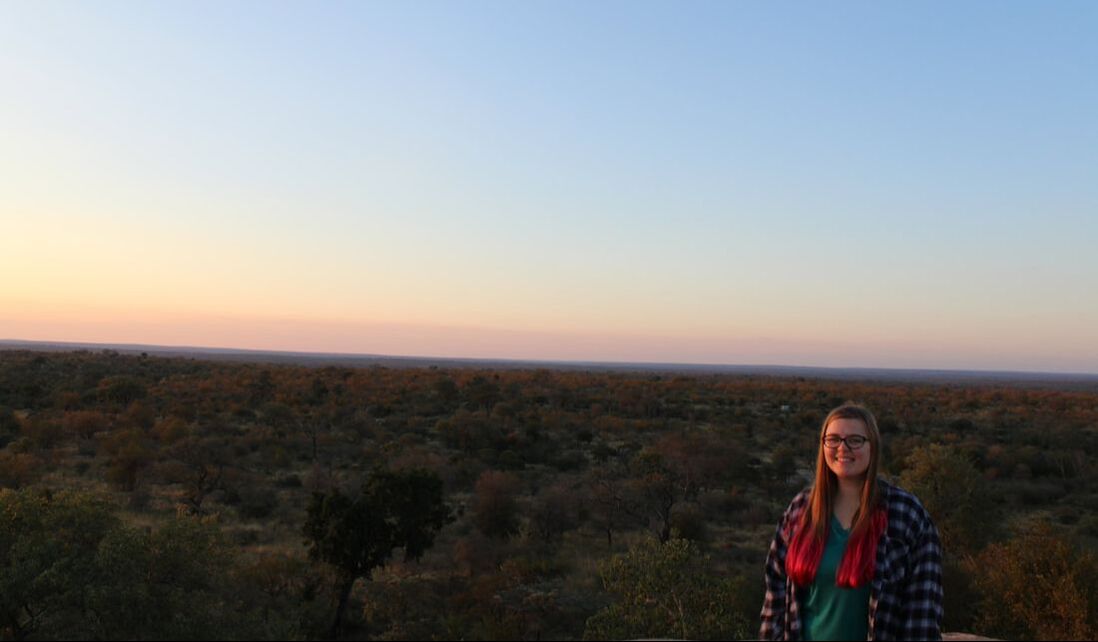 A picture of a woman in front of a savannah overlook